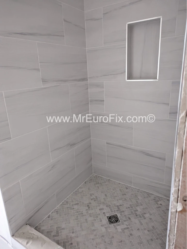 Bright and modern light-tiled shower installation